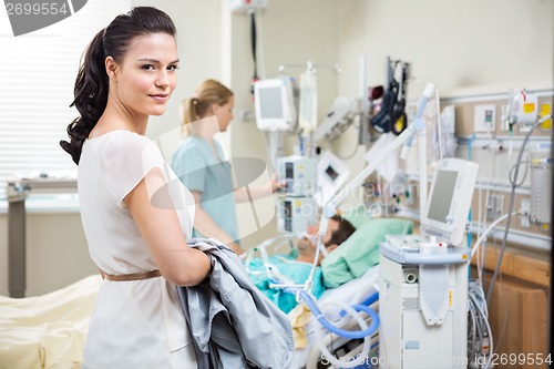 Image of Woman With Nurse Examining Male Patient