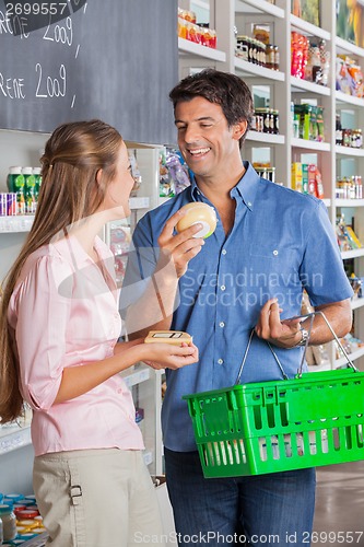 Image of Couple Comparing Cheese At Grocery Store