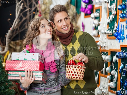 Image of Couple With Presents Shopping In Store