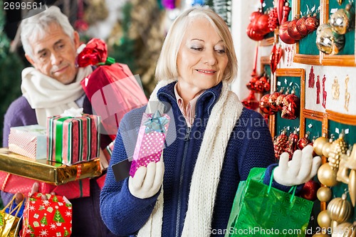 Image of Woman Selecting Christmas Ornaments At Store