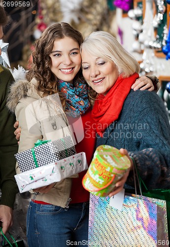 Image of Affectionate Mother And Daughter With Christmas Presents