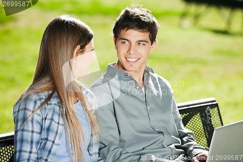 Image of Students With Laptop Looking At Each Other In Campus