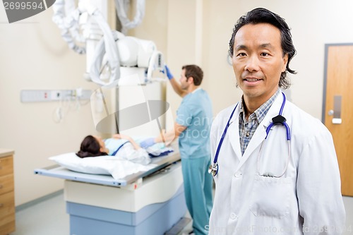 Image of Radiologist With Nurse Preparing Patient For Xray