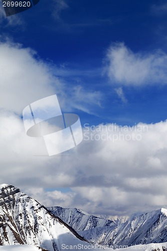 Image of Winter snowy mountains in clouds at nice day