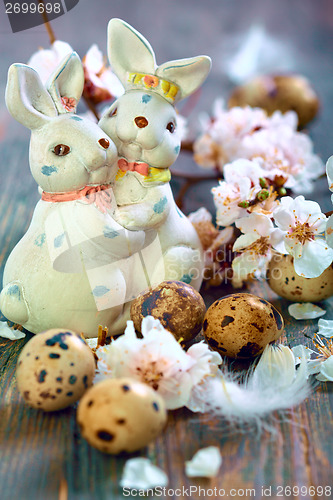 Image of Easter bunnies and apricot flowering branches.