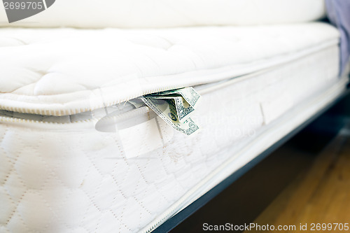 Image of Cash hidden under the mattress