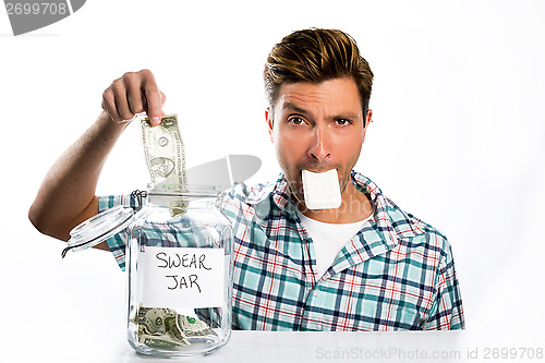 Image of Man paying a swear jar