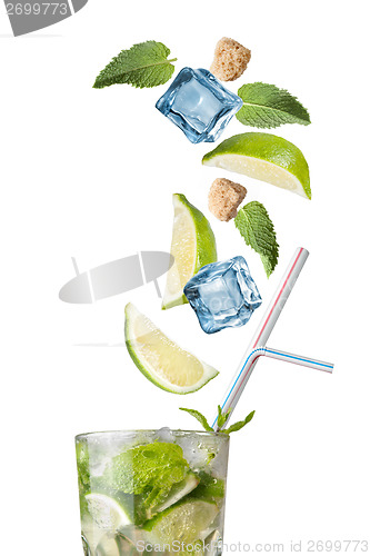 Image of mohito cocktail with falling ingredients isolated on white