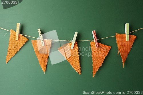 Image of Burlap Pennants Hanging on a Green Chalkboard