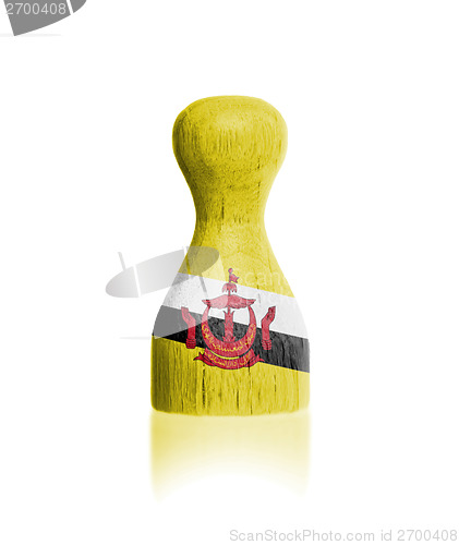 Image of Wooden pawn with a painting of a flag