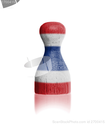 Image of Wooden pawn with a painting of a flag