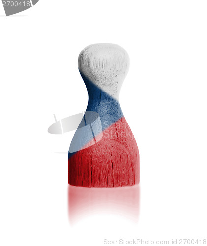 Image of Wooden pawn with a painting of a flag