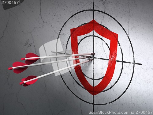 Image of Protection concept: arrows in Contoured Shield target on wall background