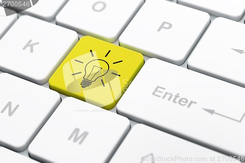 Image of Finance concept: Light Bulb on computer keyboard background