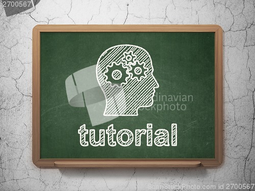 Image of Education concept: Head With Gears and Tutorial on chalkboard background