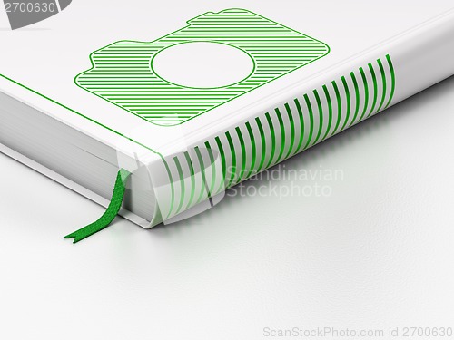 Image of Vacation concept: closed book, Photo Camera on white background