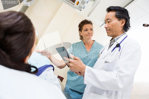 Image of Medical Team And Patient In Hospital Room