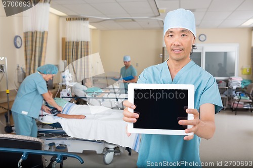 Image of Male Nurse Showing Digital Tablet In Hospital Ward