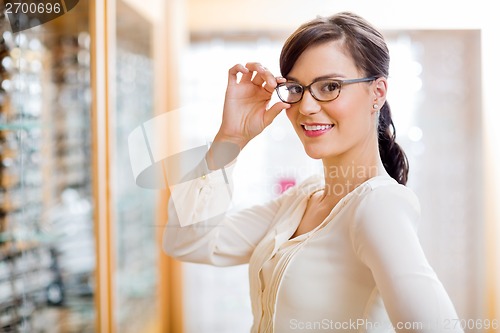 Image of Woman Trying New Glasses In Optician Store