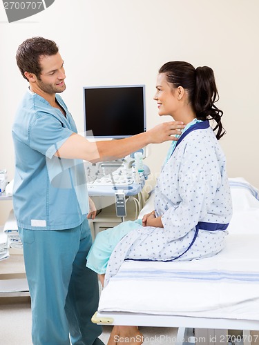 Image of Nurse Examining Patient's Neck Before Ultrasound Test