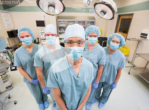 Image of Medical Team In Scrubs Standing Inside Operation Room