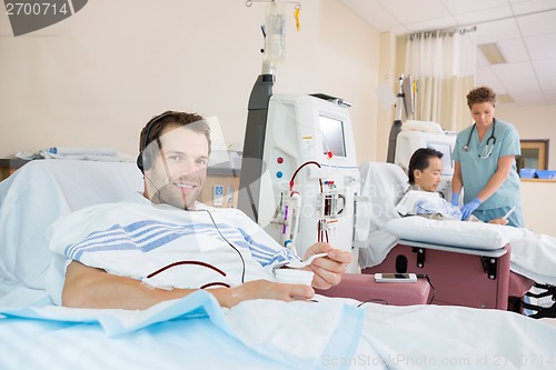 Image of Patient Holding Glass Of Crushed Ice During Renal Dialysis