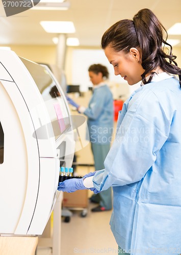 Image of Medical Lab Tech Loading Coagulation Test