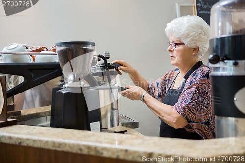 Image of Barista Making Coffee In Cafe