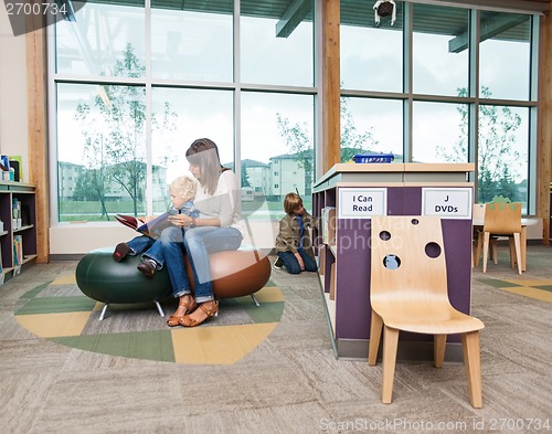 Image of Student With Teacher Reading Book In Library