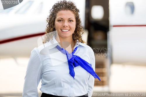 Image of Beautiful Airhostess With Private Jet In Background