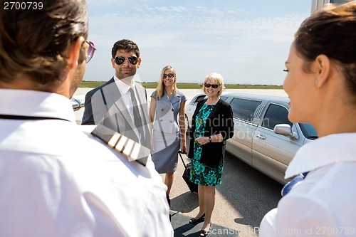 Image of Business Professionals Greeting Pilot And Airhostess At Airport