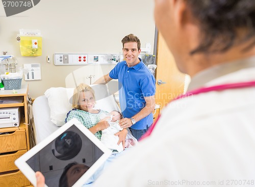 Image of Couple With Babygirl Looking At Doctor Holding Digital Tablet