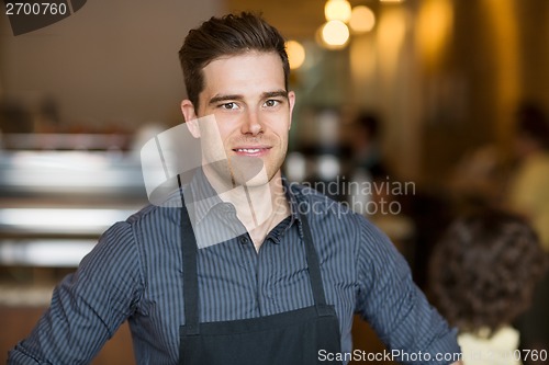 Image of Smiling Male Owner In Cafe