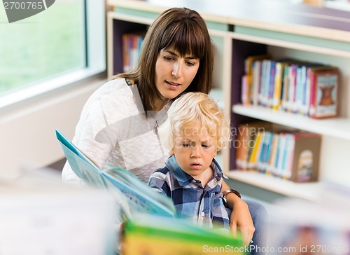 Image of Student With Teacher Reading Book In Library