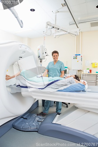 Image of Nurse With Patient In CT Scan Room