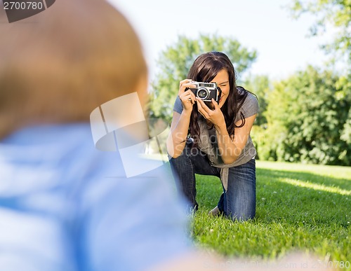 Image of Woman Photographing Baby Son