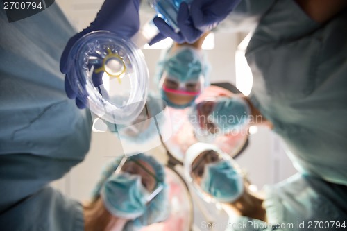 Image of Multiethnic Doctors With Oxygen Mask In Operation Room