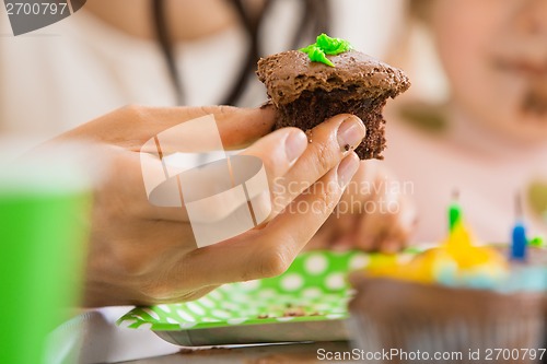 Image of Woman Holding Cupcake At Birthday Party
