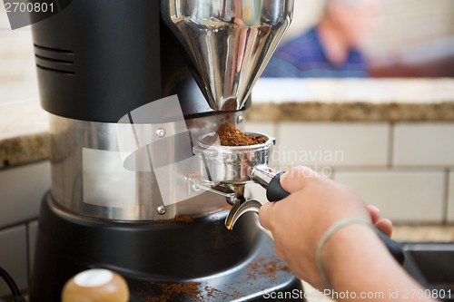 Image of Barista Grinding Coffee