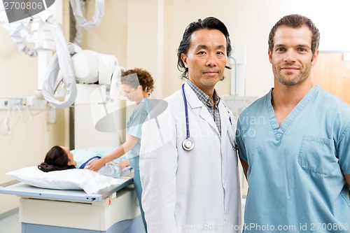 Image of Medical Team With Patient In Examination Room