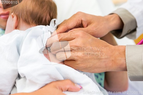 Image of Doctor's Hands Examining Newborn Babygirl With Stethoscope