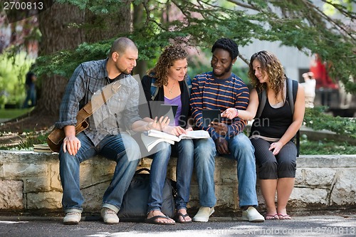 Image of University Students Using Digital Tablet On Campus