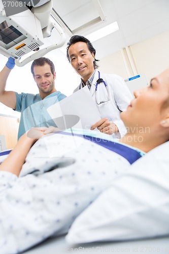 Image of Medical Team With Patient In Examination Room