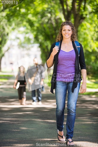 Image of Confident Female Student Walking On Campus Road