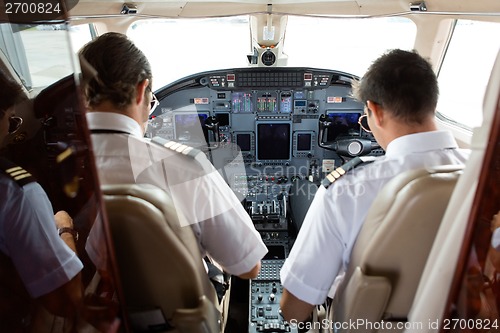 Image of Pilot And Copilot In Cockpit