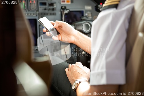 Image of Pilot Using Cell Phone In Cockpit