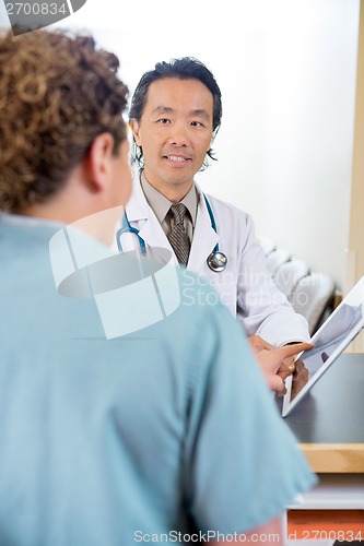 Image of Doctor And Nurse Using Digital Tablet At Reception