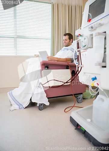 Image of Patient Using Digital Tablet During Renal Dialysis In Hospital