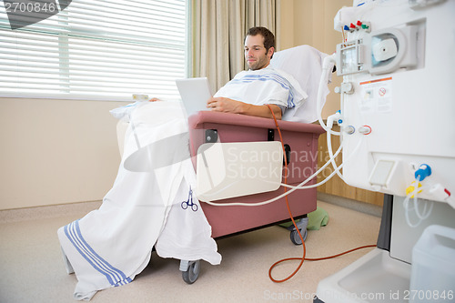 Image of Patient Using Tablet Computer Waiting for Dialysis Treatment