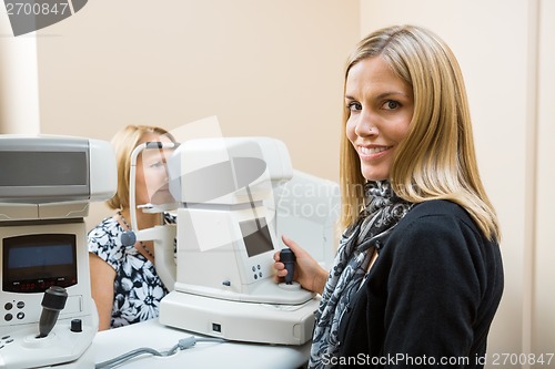 Image of Optometrist Using Tonometer to Measure Patients Eye Pressure